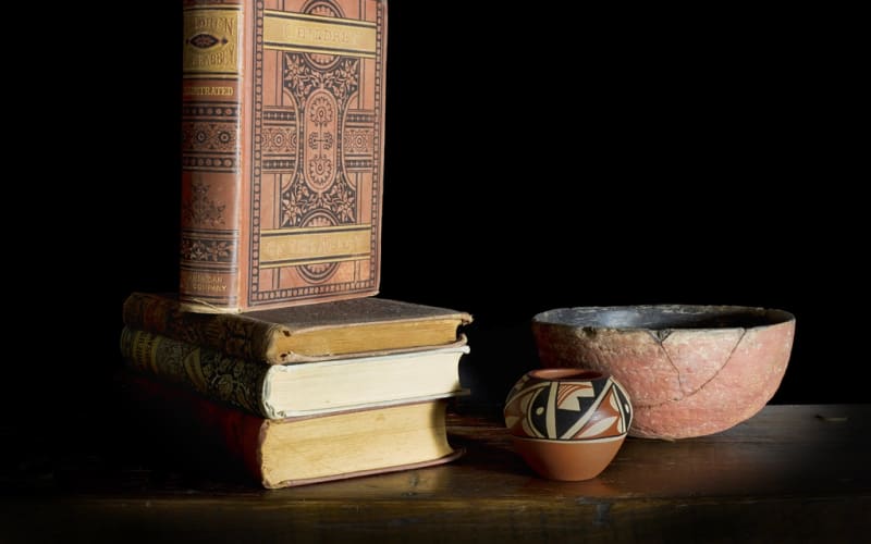 A stack of antique books on a table