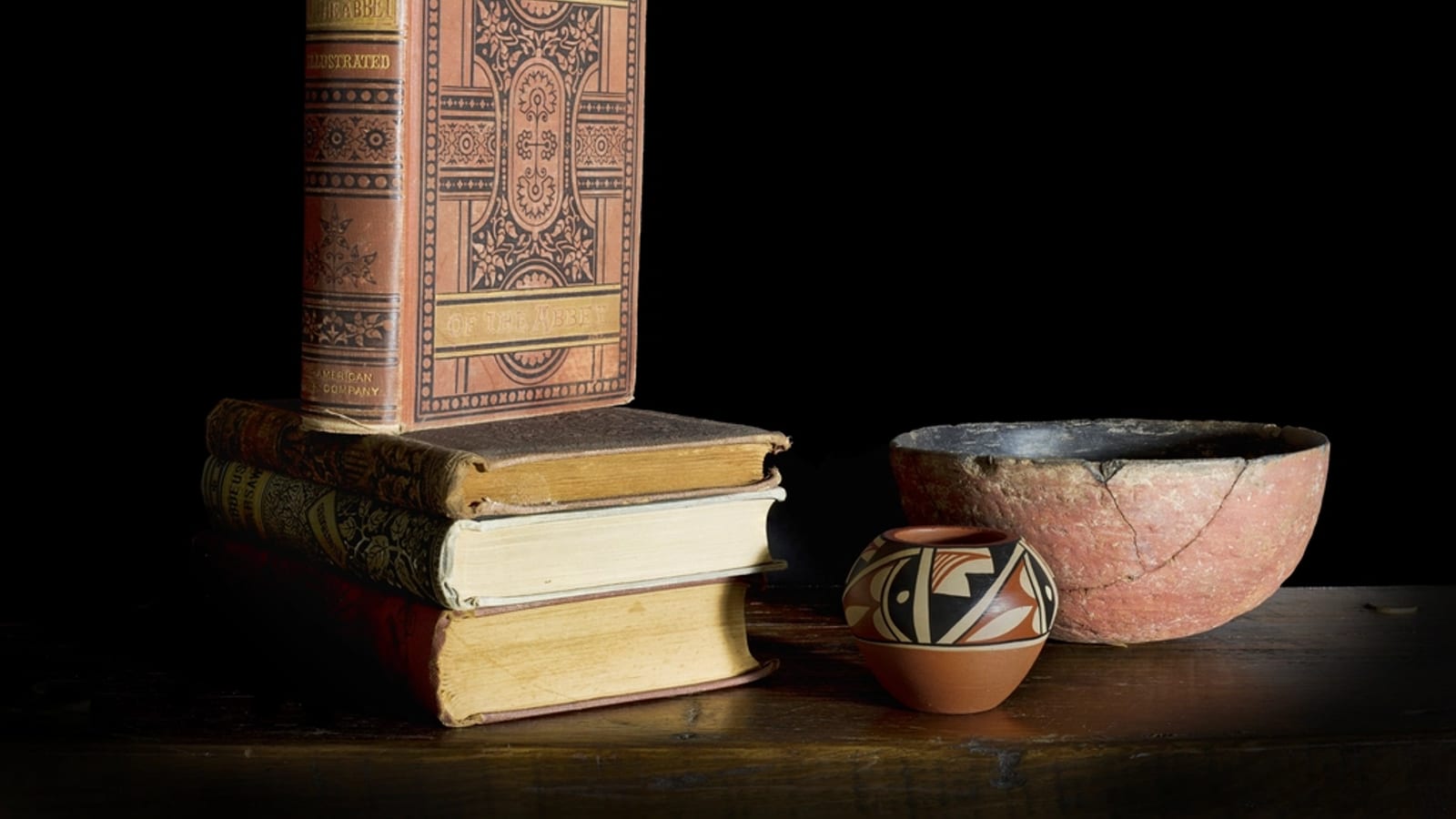 A stack of antique books on a table